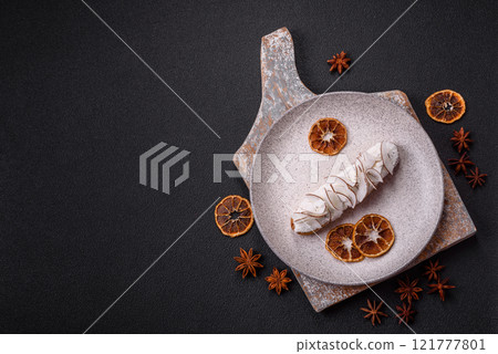 Sweet eclair with custard decorated with coconut slices 121777801