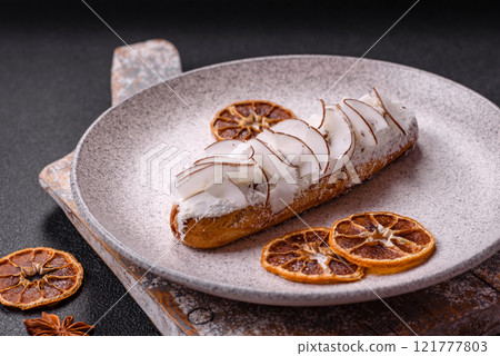 Sweet eclair with custard decorated with coconut slices 121777803