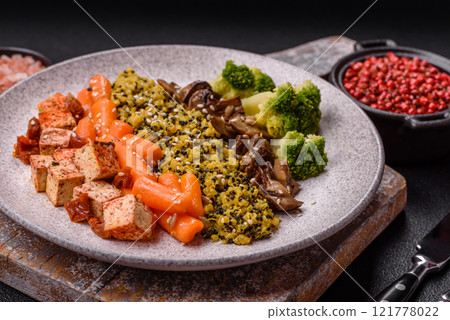 Colorful vegan vegetarian dish consists of tofu, broccoli, quinoa, mushrooms 121778022
