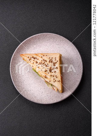 Sandwich with toast bread, meat, tomatoes, cheese, sauce, salt and spices Sandwich with toast bread, meat, tomatoes, cheese, sauce, salt and spices 121778042