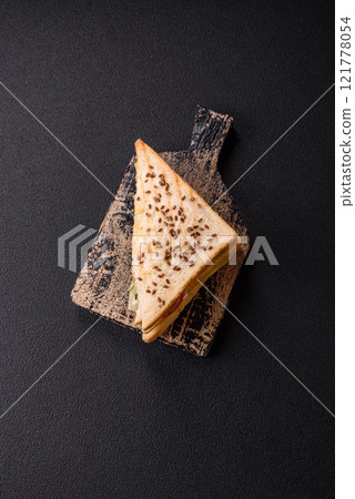 Sandwich with toast bread, meat, tomatoes, cheese, sauce, salt and spices Sandwich with toast bread, meat, tomatoes, cheese, sauce, salt and spices 121778054