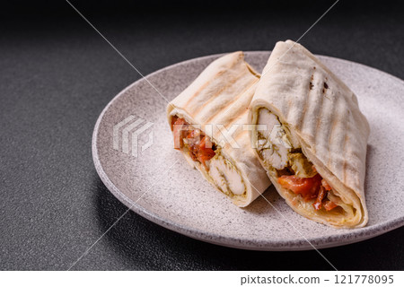 Roll with pita, meat, tomatoes, cheese, sauce, salt and spices Roll with pita, meat, tomatoes, cheese, sauce, salt and spices 121778095