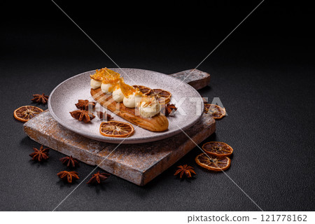 Sweet dessert eclairs or profiteroles with chocolate filling 121778162