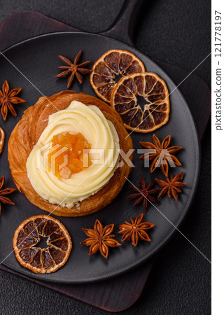 Sweet dessert danish with raisins, cream and pear filling Sweet dessert danish with raisins, cream and pear filling 121778197