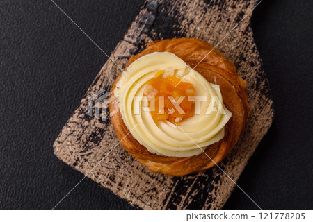 Sweet dessert danish with raisins, cream and pear filling 121778205