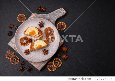 Sweet dessert danish with raisins, cream and pear filling 121778222