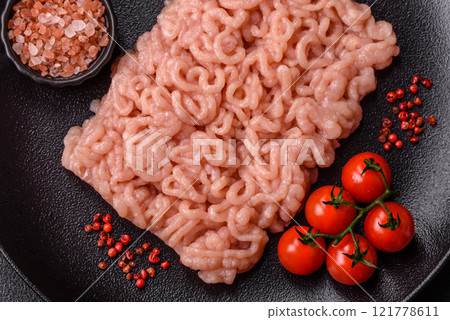Fresh raw chicken mince with salt, spices and herbs Fresh raw chicken mince with salt, spices and herbs 121778611