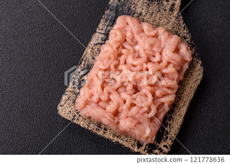 Fresh raw chicken mince with salt, spices and herbs Fresh raw chicken mince with salt, spices and herbs 121778636