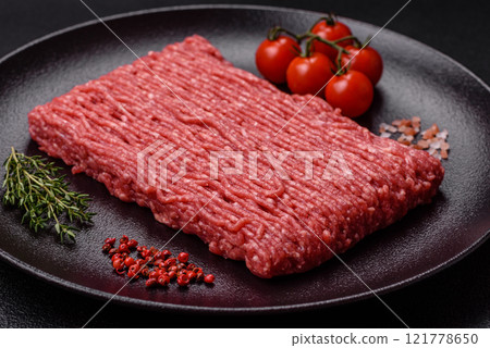 Fresh raw ground beef with salt, spices and herbs 121778650