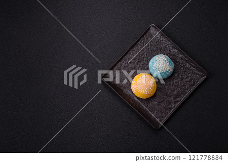 Delicious colorful asian mochi sweets with rice dough shell and fruit filling Delicious colorful asian mochi sweets with rice dough shell and fruit filling 121778884