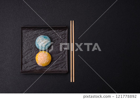 Delicious colorful asian mochi sweets with rice dough shell and fruit filling 121778892