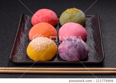 Delicious colorful asian mochi sweets with rice dough shell and fruit filling 121778909