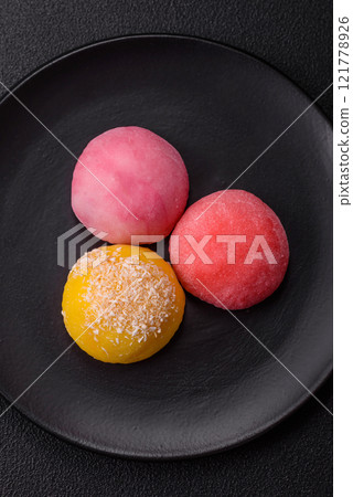 Delicious colorful asian mochi sweets with rice dough shell and fruit filling 121778926