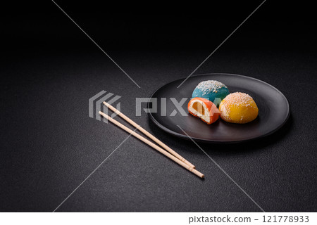 Delicious colorful asian mochi sweets with rice dough shell and fruit filling 121778933