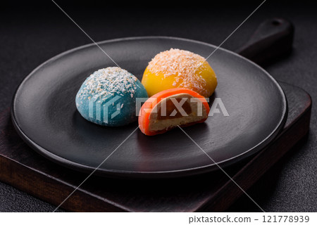 Delicious colorful asian mochi sweets with rice dough shell and fruit filling Delicious colorful asian mochi sweets with rice dough shell and fruit filling 121778939