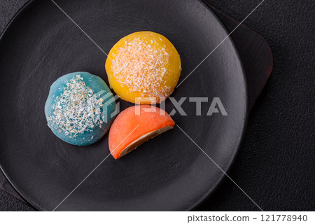 Delicious colorful asian mochi sweets with rice dough shell and fruit filling 121778940