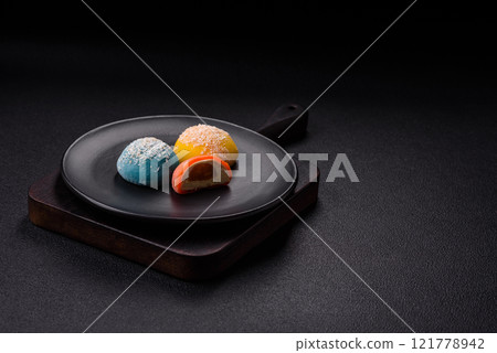 Delicious colorful asian mochi sweets with rice dough shell and fruit filling 121778942