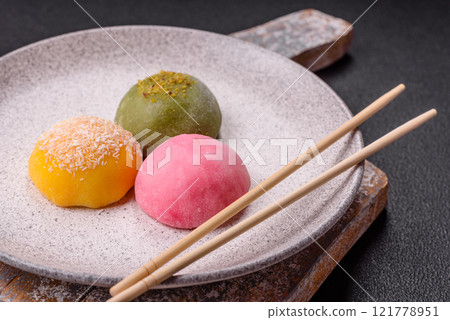 Delicious colorful asian mochi sweets with rice dough shell and fruit filling Delicious colorful asian mochi sweets with rice dough shell and fruit filling 121778951