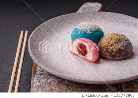 Delicious colorful asian mochi sweets with rice dough shell and fruit filling Delicious colorful asian mochi sweets with rice dough shell and fruit filling 121778962