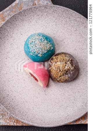 Delicious colorful asian mochi sweets with rice dough shell and fruit filling Delicious colorful asian mochi sweets with rice dough shell and fruit filling 121778964
