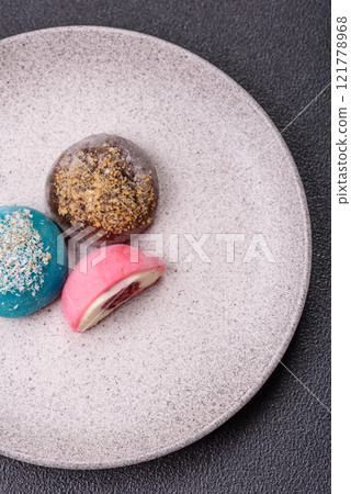 Delicious colorful asian mochi sweets with rice dough shell and fruit filling 121778968