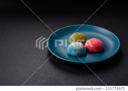Delicious colorful asian mochi sweets with rice dough shell and fruit filling Delicious colorful asian mochi sweets with rice dough shell and fruit filling 121778972
