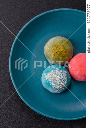 Delicious colorful asian mochi sweets with rice dough shell and fruit filling Delicious colorful asian mochi sweets with rice dough shell and fruit filling 121778977