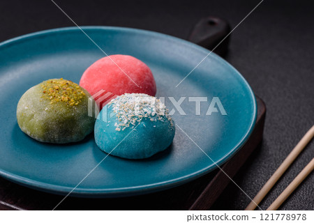 Delicious colorful asian mochi sweets with rice dough shell and fruit filling Delicious colorful asian mochi sweets with rice dough shell and fruit filling 121778978