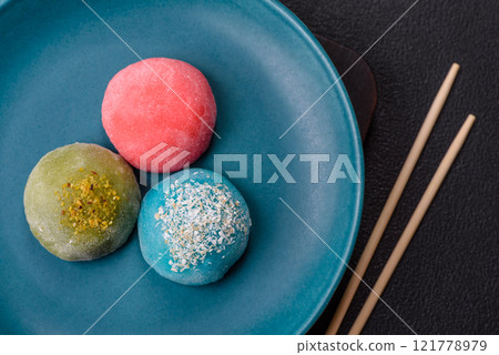 Delicious colorful asian mochi sweets with rice dough shell and fruit filling Delicious colorful asian mochi sweets with rice dough shell and fruit filling 121778979