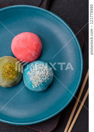Delicious colorful asian mochi sweets with rice dough shell and fruit filling Delicious colorful asian mochi sweets with rice dough shell and fruit filling 121778980