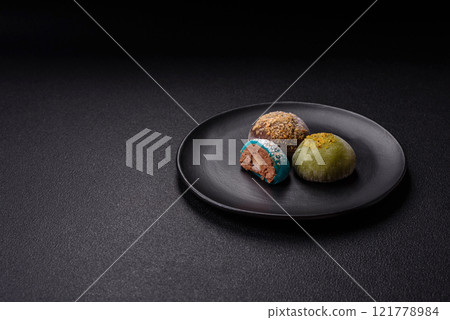 Delicious colorful asian mochi sweets with rice dough shell and fruit filling 121778984