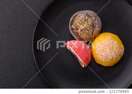Delicious colorful asian mochi sweets with rice dough shell and fruit filling 121778993