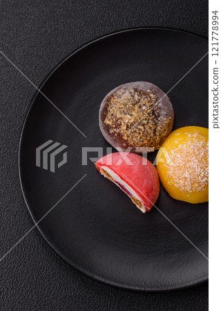 Delicious colorful asian mochi sweets with rice dough shell and fruit filling Delicious colorful asian mochi sweets with rice dough shell and fruit filling 121778994