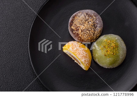 Delicious colorful asian mochi sweets with rice dough shell and fruit filling Delicious colorful asian mochi sweets with rice dough shell and fruit filling 121778996