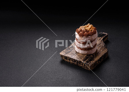 Sweet puff tart with meringue, cream and nuts Sweet puff tart with meringue, cream and nuts 121779041
