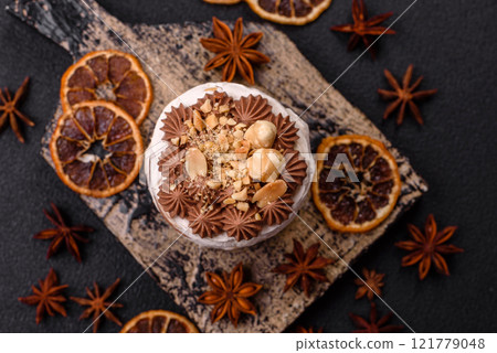 Sweet puff tart with meringue, cream and nuts 121779048