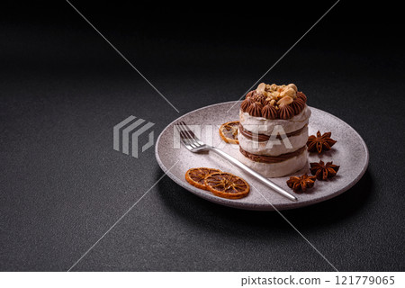 Sweet puff tart with meringue, cream and nuts 121779065