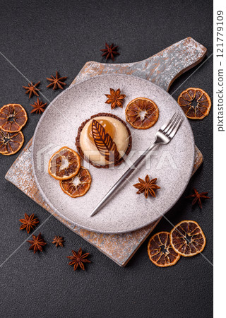 Sweet tart with pear lemon mousse cream and chocolate cake base 121779109