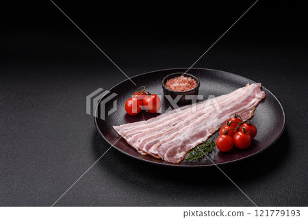 Fresh raw bacon sliced with spices and herbs 121779193