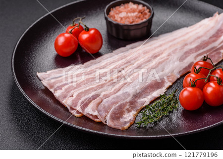 Fresh raw bacon sliced with spices and herbs 121779196