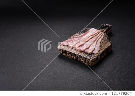 Fresh raw bacon sliced with spices and herbs Fresh raw bacon sliced with spices and herbs 121779204