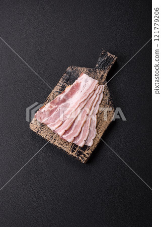 Fresh raw bacon sliced with spices and herbs Fresh raw bacon sliced with spices and herbs 121779206