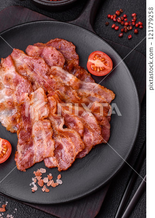 Delicious crispy bacon grilled with salt and spices 121779258