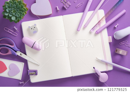 Open notepad and stationery, felt-tip pens, stapler, ruler, eraser, pins, clips in purple theme. Space for your text. Open notepad and stationery, felt-tip pens, stapler, ruler, eraser, pins, clips in purple theme. Space for your text. 121779325