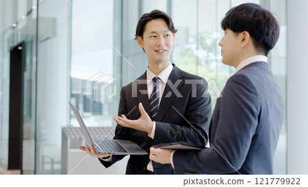 Businessmen having a meeting in the lobby Businessmen having a meeting in the lobby 121779922