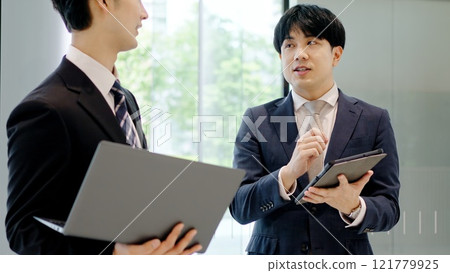 Businessmen having a meeting in the lobby 121779925