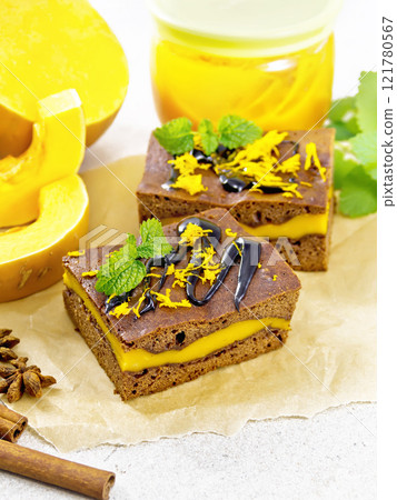 Cake chocolate with pumpkin layer on granite countertop Cake chocolate with pumpkin layer on granite countertop 121780567