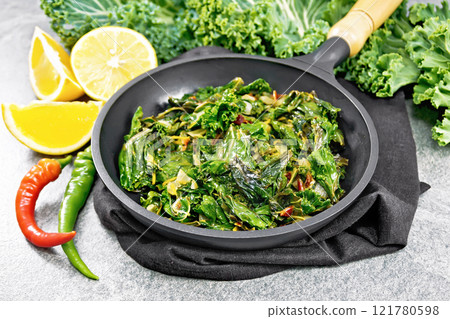 Kale cabbage with orange and pepper in pan on stone table Kale cabbage with orange and pepper in pan on stone table 121780598