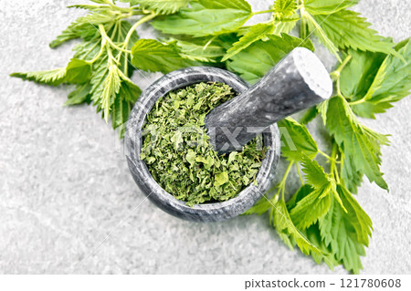 Nettle dried in mortar on stone top Nettle dried in mortar on stone top 121780608