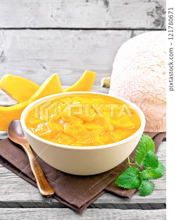 Pumpkin puree in bowl on wooden board Pumpkin puree in bowl on wooden board 121780671